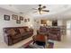 Open living room featuring tray ceilings and view of the kitchen with breakfast bar seating at 410 Majestic Gardens Blvd, Winter Haven, FL 33880