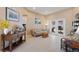 Bright living room featuring neutral walls, tile flooring, comfortable seating, and access to the outdoor area at 410 Majestic Gardens Blvd, Winter Haven, FL 33880