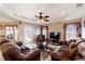 Bright and spacious living room with tray ceilings, comfortable seating, and a view of the patio at 410 Majestic Gardens Blvd, Winter Haven, FL 33880