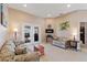 Cozy living room with tile flooring, comfortable seating, and a sliding door leading to the outdoor space at 410 Majestic Gardens Blvd, Winter Haven, FL 33880