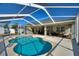 Relax on the patio with a pool and outdoor seating under the screened enclosure at 410 Majestic Gardens Blvd, Winter Haven, FL 33880