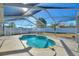 Private pool with screened enclosure and ample patio space for outdoor enjoyment at 410 Majestic Gardens Blvd, Winter Haven, FL 33880