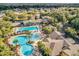 Aerial view of the community pool and recreation area, showcasing lush landscaping and multiple amenities at 4419 Clear Brook Ct, Leesburg, FL 34748