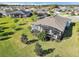 Spacious backyard featuring a screened lanai and lush green lawn, perfect for outdoor entertaining and relaxation at 4419 Clear Brook Ct, Leesburg, FL 34748