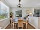 Cozy dining area with modern chandelier, natural light, and seating for four at 4419 Clear Brook Ct, Leesburg, FL 34748