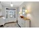 Elegant foyer featuring a decorative front door, stylish wooden floors, and a charming storage console at 4419 Clear Brook Ct, Leesburg, FL 34748