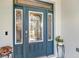 Beautiful front door with decorative glass panels, a secure lock system, and a potted plant at 4419 Clear Brook Ct, Leesburg, FL 34748