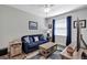 Cozy living room with plush blue sofa, area rug, and decorative elements at 4419 Clear Brook Ct, Leesburg, FL 34748