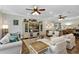 Inviting living room with comfortable seating, neutral tones, and a view into the adjacent dining area at 4419 Clear Brook Ct, Leesburg, FL 34748