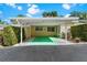 Carport of the home features green painted concrete at 450 Liberty Ave # 3, Mount Dora, FL 32757