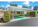 Carport of the home features green painted concrete at 450 Liberty Ave # 3, Mount Dora, FL 32757