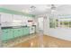 Bright kitchen with retro green and white cabinets and modern appliances, blending style and function at 450 Liberty Ave # 3, Mount Dora, FL 32757