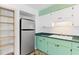 Traditional kitchen featuring sleek stainless steel refrigerator, built-in shelves, and double basin sink at 450 Liberty Ave # 3, Mount Dora, FL 32757