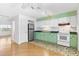 Bright kitchen with retro green and white cabinets and modern appliances, blending style and function at 450 Liberty Ave # 3, Mount Dora, FL 32757