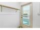 Well-lit mud room with a door to the exterior with a wooden shelf on a white cinder block wall at 450 Liberty Ave # 3, Mount Dora, FL 32757