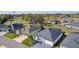 Aerial view of several homes in a community with manicured lawns and mature trees at 4521 Whittingtin Circle, The Villages, FL 32163