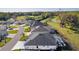 Scenic aerial view of the neighborhood with well-maintained landscaping, screened pools, and surrounding green spaces at 4521 Whittingtin Circle, The Villages, FL 32163