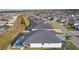 Aerial view of screened-in lanai with pool and exterior of home in a residential neighborhood at 4521 Whittingtin Circle, The Villages, FL 32163