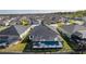 Wide aerial perspective showcasing the community's well-planned layout and the screened-in pools at 4521 Whittingtin Circle, The Villages, FL 32163