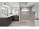 Bright bathroom featuring dual vanity, glass enclosed shower, and tile floor at 4521 Whittingtin Circle, The Villages, FL 32163