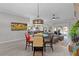 Dining room with statement light fixture, seats four, and leads to the living room at 4521 Whittingtin Circle, The Villages, FL 32163