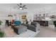 Open-concept living room with a modern kitchen, gray sofa and statement rug at 4521 Whittingtin Circle, The Villages, FL 32163