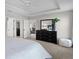 Bright main bedroom featuring closet and dresser with large mirror, carpet flooring, and crown molding at 4521 Whittingtin Circle, The Villages, FL 32163