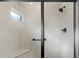 Modern shower with black hardware, a built-in bench, and a small window at 4521 Whittingtin Circle, The Villages, FL 32163