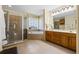 Bathroom featuring double sinks, a glass shower, and a tub at 4571 Abaco Dr, Tavares, FL 32778