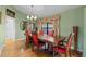 Formal dining room with hardwood floors, a decorative chandelier, and stylish window treatments at 4571 Abaco Dr, Tavares, FL 32778