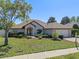 Charming single-story home featuring lush landscaping, a well-manicured lawn, and a welcoming entrance at 4571 Abaco Dr, Tavares, FL 32778