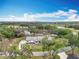 Aerial view of the home surrounded by mature trees on a picturesque lot in a beautiful community at 464 Long & Winding Rd, Groveland, FL 34736