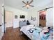 Bedroom with hardwood floors, ceiling fan, and a closet with barn door at 464 Long & Winding Rd, Groveland, FL 34736