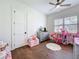 bedroom features hardwood flooring, a large window, and playful decor at 464 Long & Winding Rd, Groveland, FL 34736