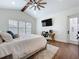 Bright bedroom with a vaulted ceiling, ceiling fan, a dedicated workspace, and a neutral color scheme at 464 Long & Winding Rd, Groveland, FL 34736