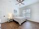 Bedroom featuring neutral decor, natural light from the window, and hardwood flooring at 464 Long & Winding Rd, Groveland, FL 34736