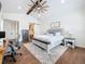 Primary bedroom featuring a ceiling fan, a work desk, and a closet with sliding barn door at 464 Long & Winding Rd, Groveland, FL 34736