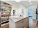 Spacious walk-in closet with custom shelving and an island for organizing accessories, shoes, and clothing at 464 Long & Winding Rd, Groveland, FL 34736