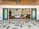 Covered patio with dark window trim, tiled floor and a seamless transition to the indoor living space at 464 Long & Winding Rd, Groveland, FL 34736