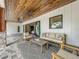 Relaxing covered patio featuring comfortable seating, wood ceilings, and serene views at 464 Long & Winding Rd, Groveland, FL 34736