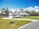 Charming two-story home with a manicured lawn, paved driveway and a neutral color palette at 464 Long & Winding Rd, Groveland, FL 34736