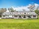 Charming two-story farmhouse featuring a metal roof, stone accents, dormer windows, and a welcoming front porch at 464 Long & Winding Rd, Groveland, FL 34736