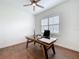 Bright home office featuring wood floors, a ceiling fan, and a window at 464 Long & Winding Rd, Groveland, FL 34736