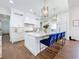 Bright kitchen with white cabinets, marble countertops, gold accents, and a center island with seating at 464 Long & Winding Rd, Groveland, FL 34736