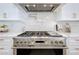 Gourmet kitchen featuring stainless steel appliances, marble countertops, and a pot filler at 464 Long & Winding Rd, Groveland, FL 34736