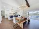 Open concept dining area flows to a well-appointed kitchen and showcases hardwood floors and natural light at 464 Long & Winding Rd, Groveland, FL 34736