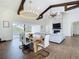 Open floor plan with dining area and living room with hardwood floors and stone fireplace at 464 Long & Winding Rd, Groveland, FL 34736