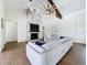 Bright living room featuring a stone fireplace, hardwood floors, and modern lighting at 464 Long & Winding Rd, Groveland, FL 34736