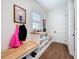 Mudroom with built-in storage, wood accents, and a bright, welcoming atmosphere at 464 Long & Winding Rd, Groveland, FL 34736