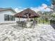 An outdoor bar with seating and a thatched roof offers a great space for backyard entertaining at 464 Long & Winding Rd, Groveland, FL 34736